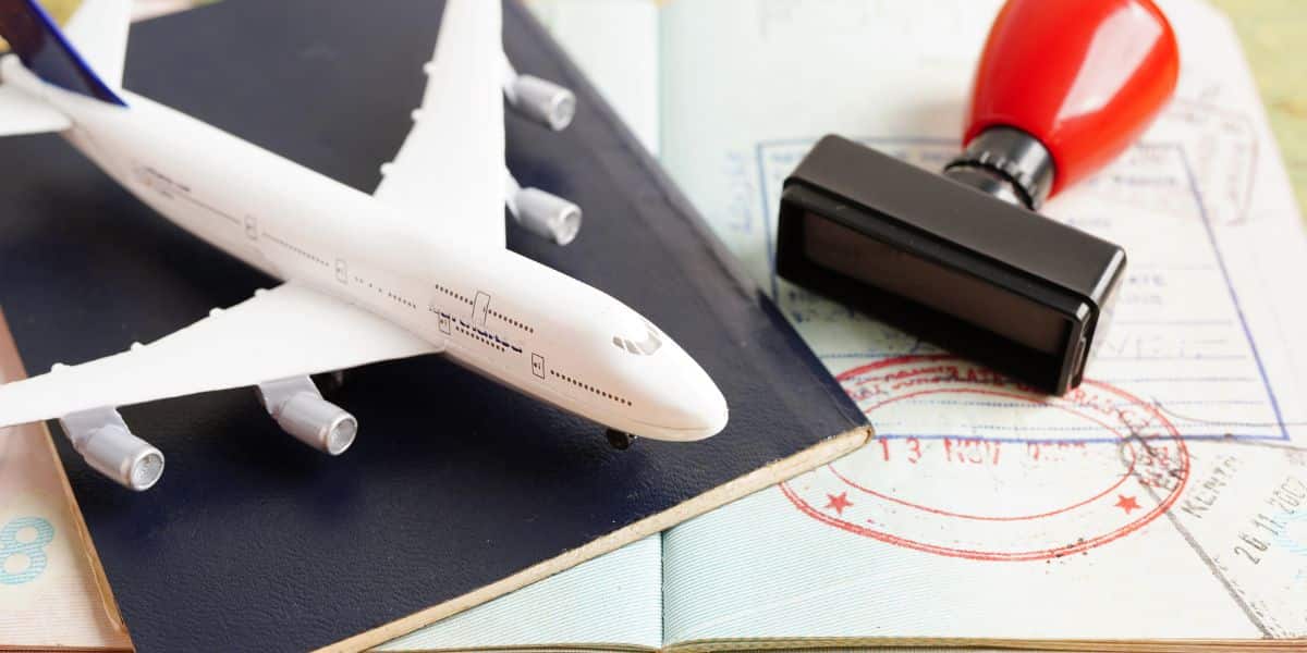 Close-up of a UAE residency visa stamp in a passport with immigration documents and fine calculation sheets on a desk