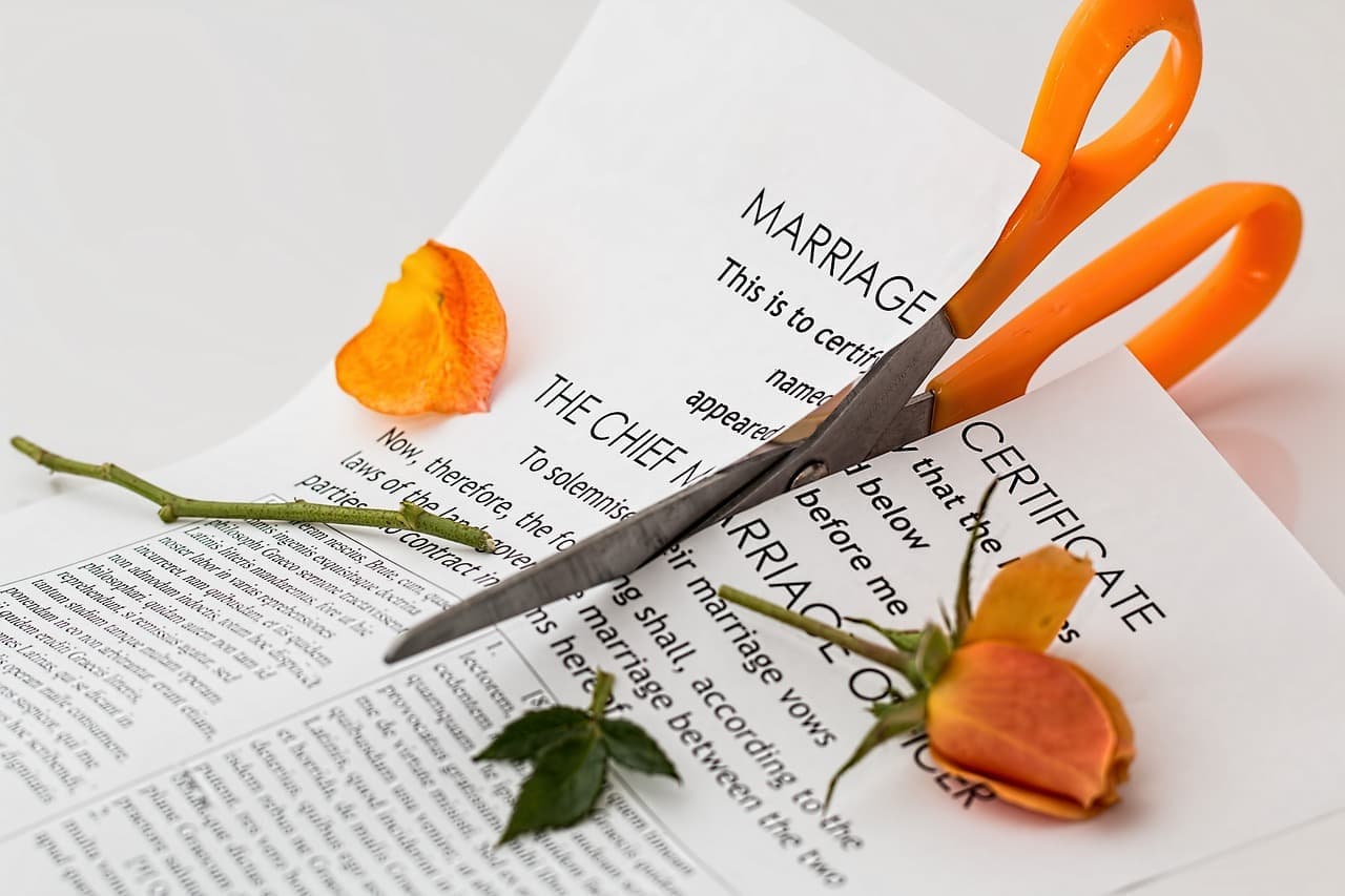 Close-up of a family law court document with a gavel and financial statements on a wooden desk