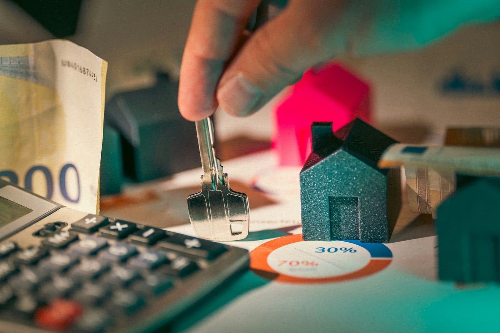 Close-up of a residential tenancy contract and keys on a desk with a Dubai property listing document showing rental details