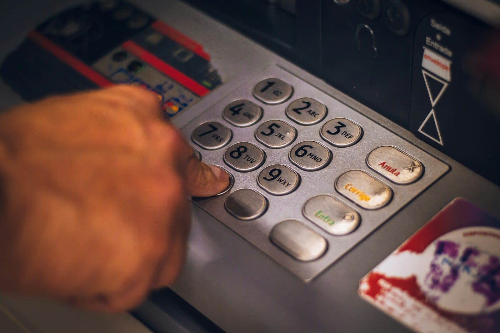 Close-up of a UAE bank card placed on top of frozen account statement documents with a padlock icon overlay