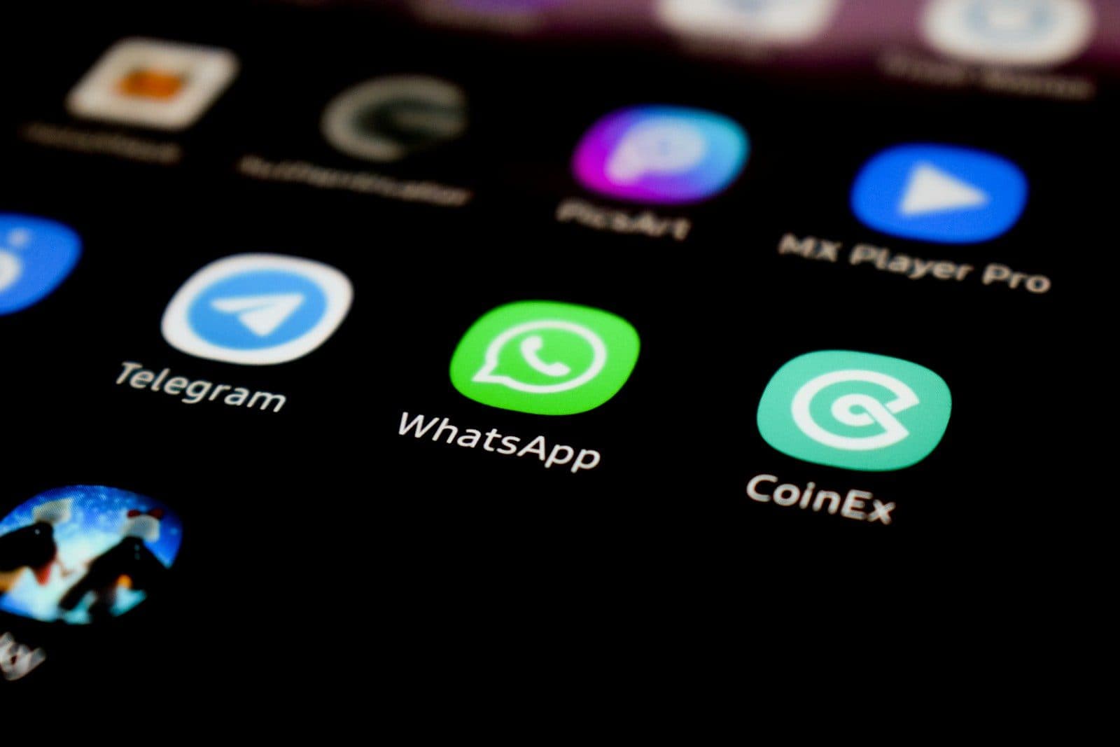Close-up of a smartphone screen displaying a WhatsApp chat interface with a video message thumbnail, placed on a desk beside legal documents