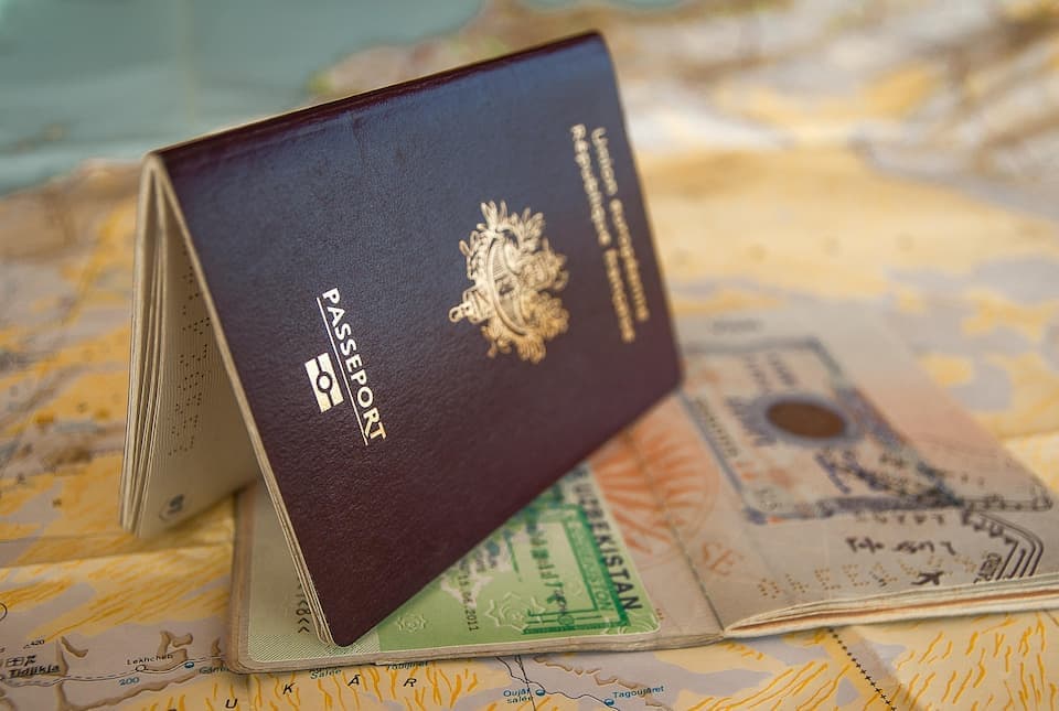 UAE residence visa document and blocked establishment card representing the challenge of cancelling a visa when a sponsor company has closed