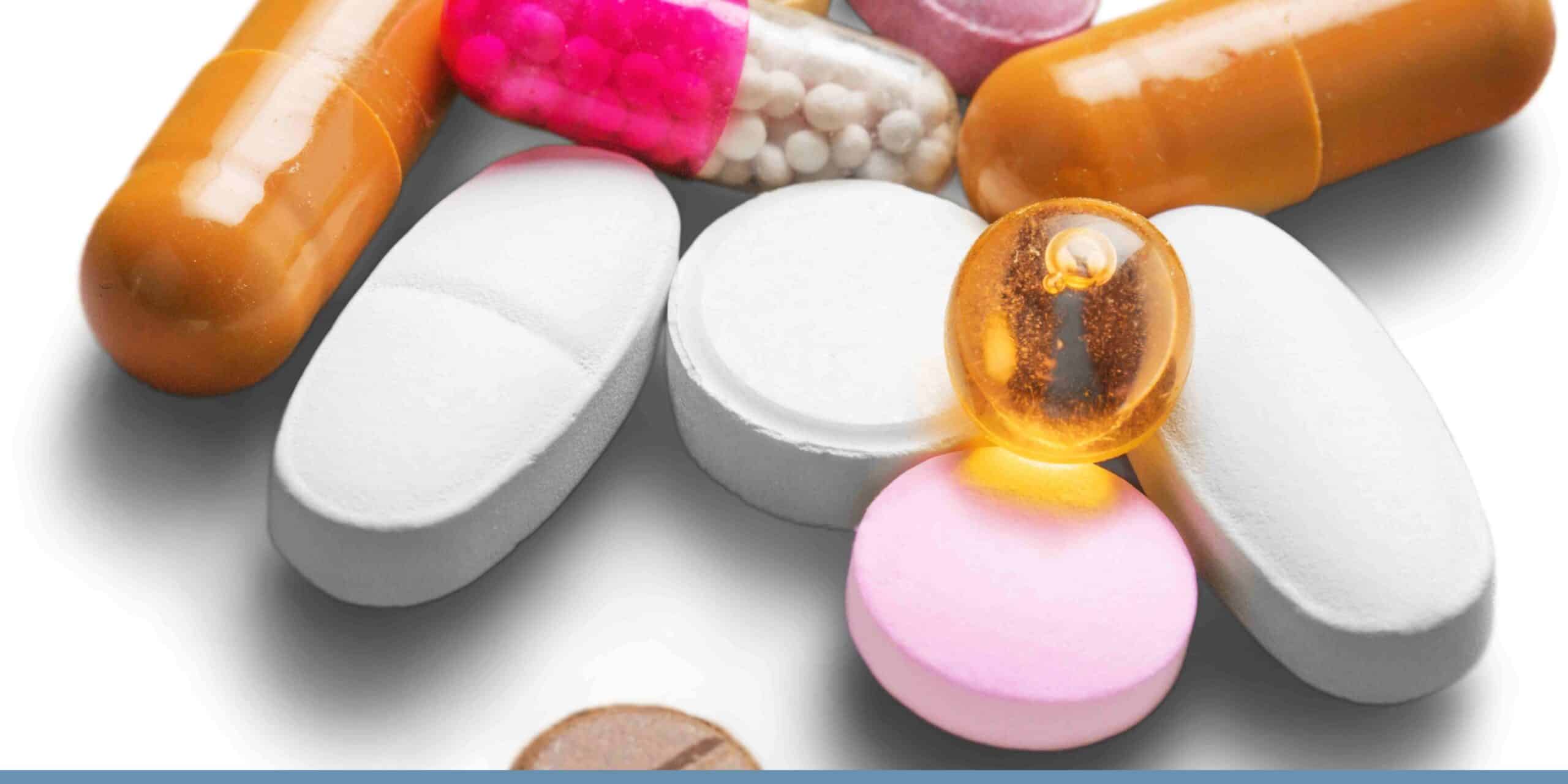 Close-up of prescription medicine bottles and blister packs on a customs inspection desk at an airport