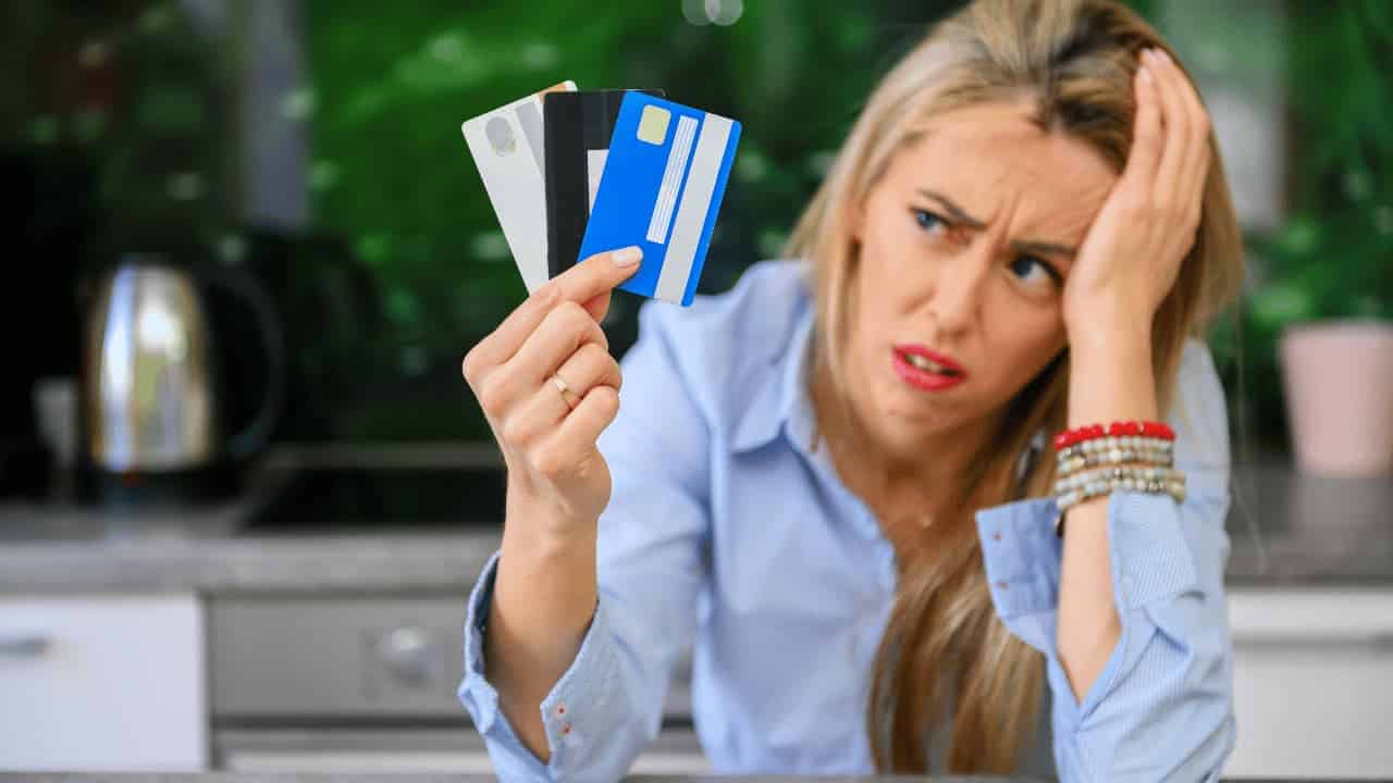 Close-up of credit cards placed on a desk next to financial documents and a calculator in a UAE office setting