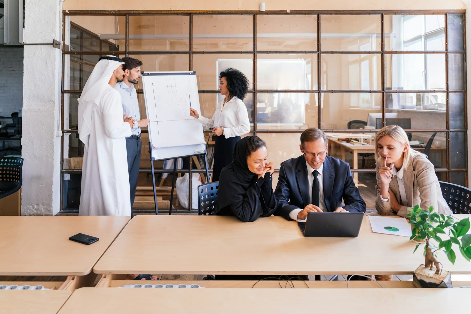 Modern office workspace in the UAE with employment contract documents and labor law reference materials on a desk