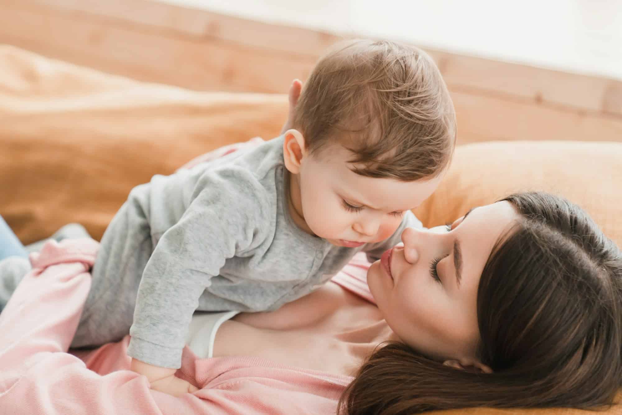 A mother and child sitting together in a family law attorney's office reviewing custody documents on a desk