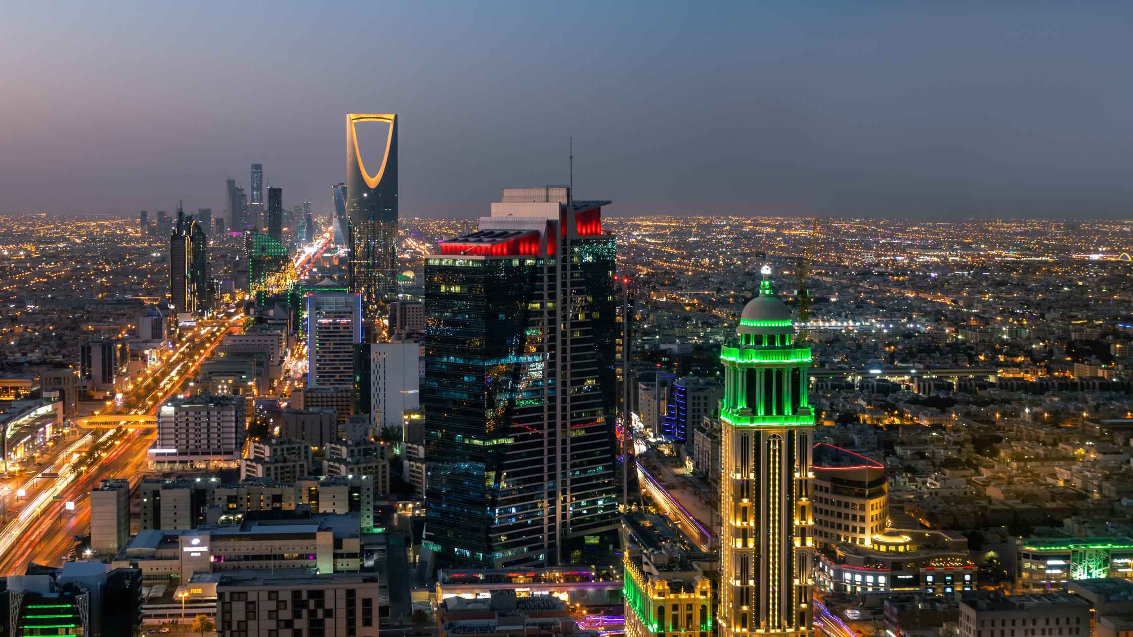 Official Saudi Arabian government document with national emblem and Arabic text on a desk
