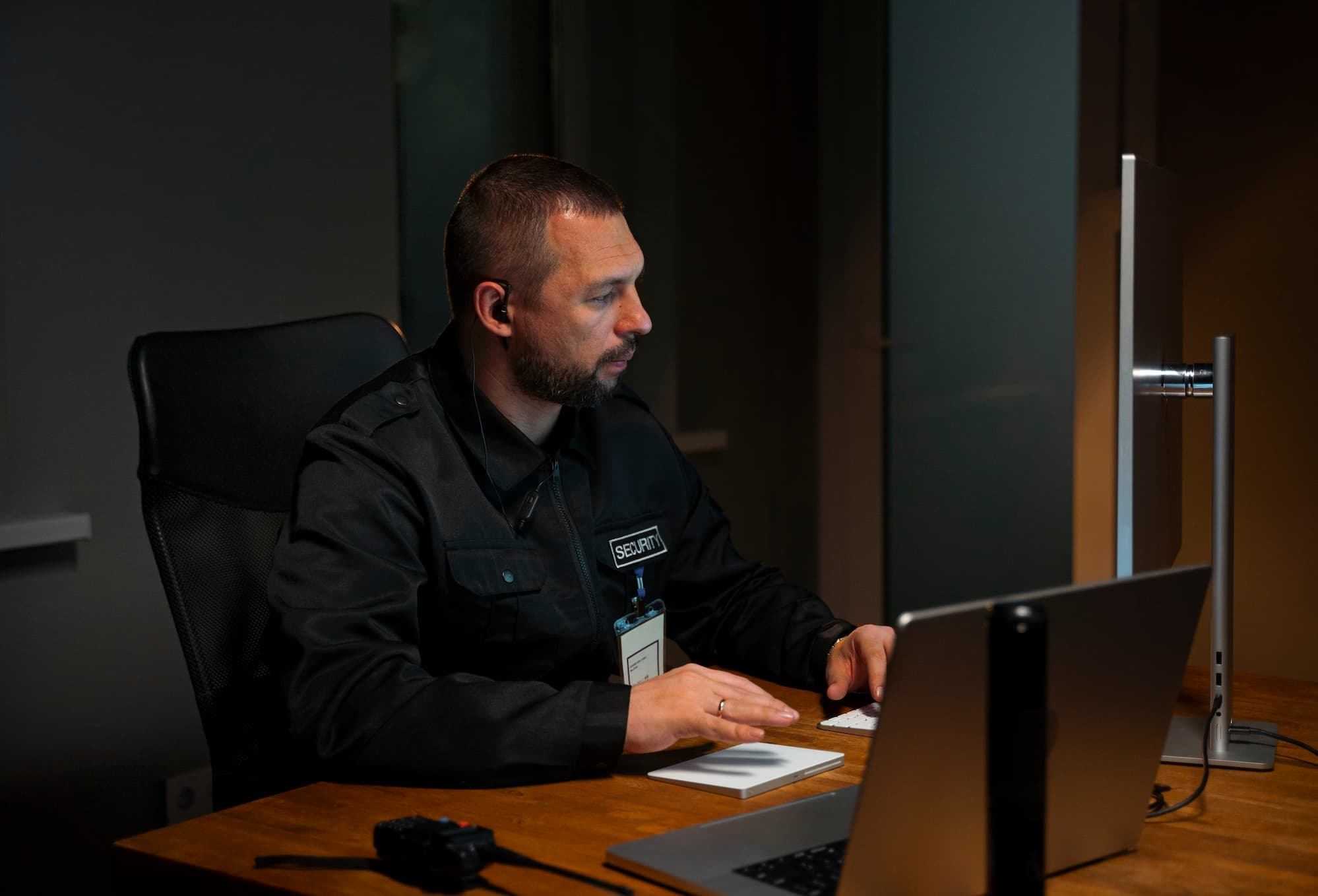 Close-up of fingerprint scanning device and official security clearance documents on a desk at a UAE government office