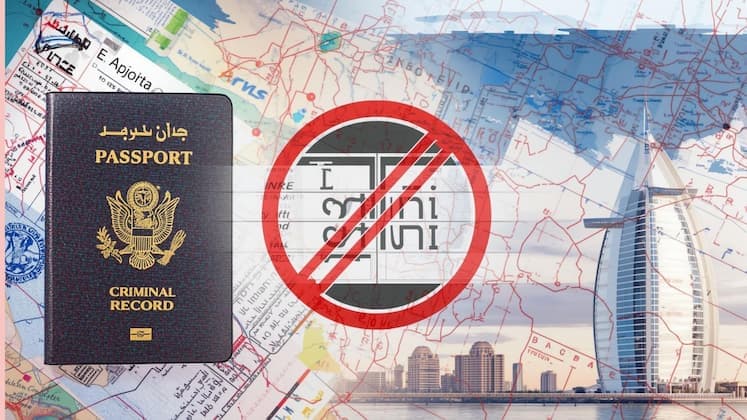 Passport control desk at Dubai International Airport with immigration officer reviewing travel documents and computer screen