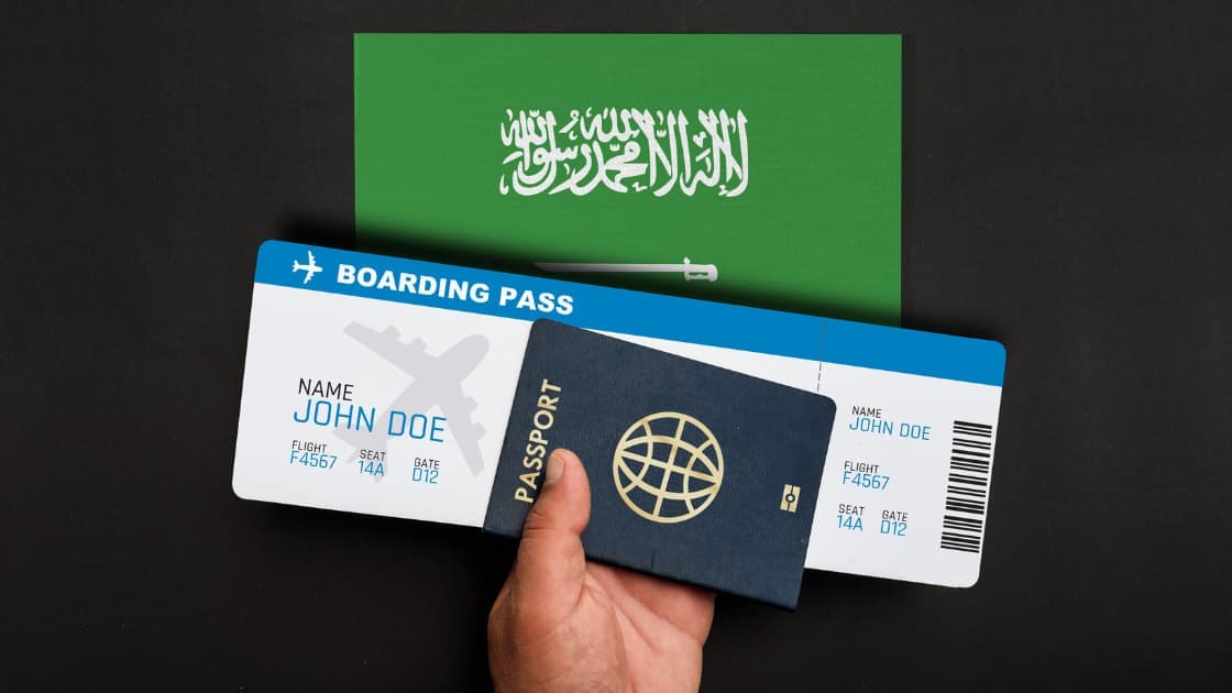 Close-up of a Saudi Arabian passport with digital interface elements showing travel restriction status on a computer screen